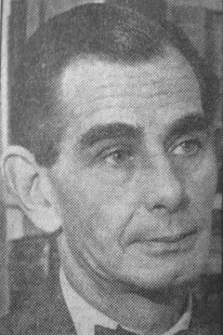 tom-fallon A grainy, black and white, close-up photograph captures the face of a man identified as Tom Fallon. He is looking slightly to the left, with his right ear visible and his dark hair neatly combed to the side. The man is wearing a dark suit jacket and a bow tie.